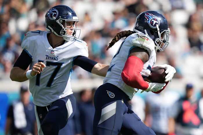 Oct 10, 2021; Jacksonville, Florida, USA; Tennessee Titans quarterback Ryan Tannehill (17) hands the ball to running back Derrick Henry (22) during the second half against the Jacksonville Jaguars at TIAA Bank Field. Mandatory Credit: Jasen Vinlove-USA TODAY Sports